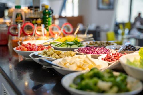 a buffet with many plates of food on a table at Hilton Garden Inn Mbabane in Mbabane