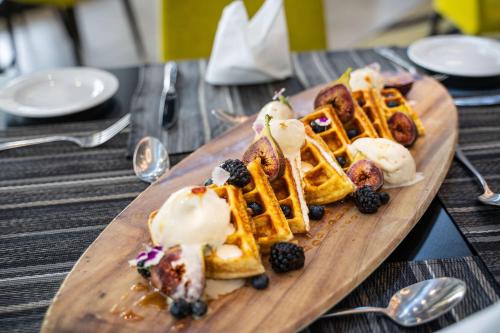 a plate of waffles and ice cream on a table at Hilton Garden Inn Mbabane in Mbabane