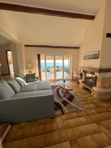 a living room with a couch and a fireplace at Villa Anchor in Zadar