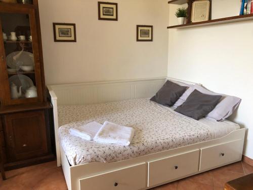 a bed with two pillows on it in a room at Brekkafest in San Giuliano Terme