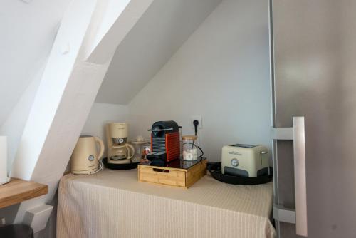 a room with a table with some appliances on it at Chez Manou, appt spacieux et élégant proche mer in Ault