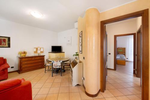 a living room with a table and a dining room at Casa Elli in Osio Sotto