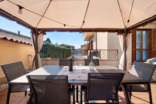 a table and chairs under an umbrella on a patio at Casa Elli in Osio Sotto