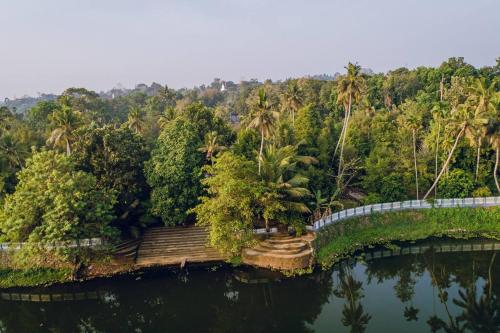 an aerial view of a bridge over a river at Meenachil Creek Homestay in Kottayam