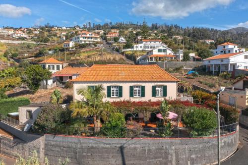 a house on a hill with houses at Cozy Villa Flora by Holiday Rental Madeira in Estreito da Calheta