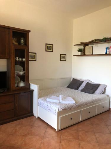a bedroom with a bed and a wooden cabinet at Brekkafest in San Giuliano Terme