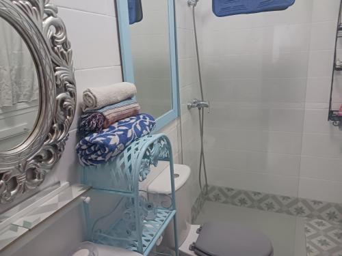 a bathroom with a mirror and a towel rack at Habitación privada con baño. in Cádiz