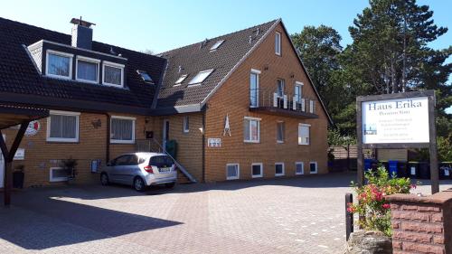 a car parked in front of a brick building at Pension Haus Erika in Cuxhaven