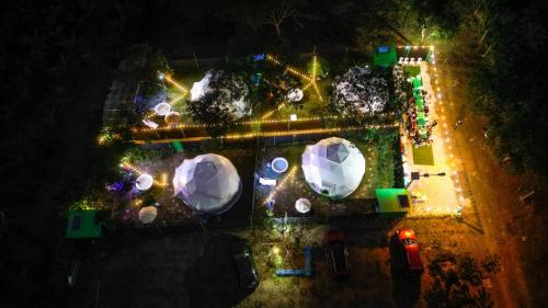 an overhead view of a park at night with lights at Paraiso Tropical Glamping in San Antonio