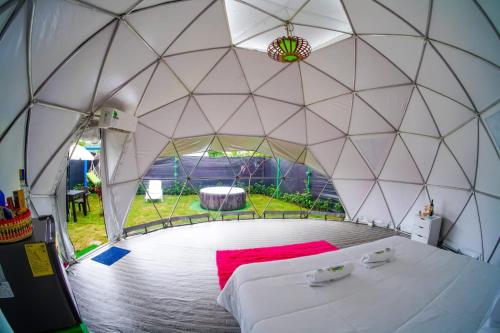 a large white tent with a bed in it at Paraiso Tropical Glamping in San Antonio