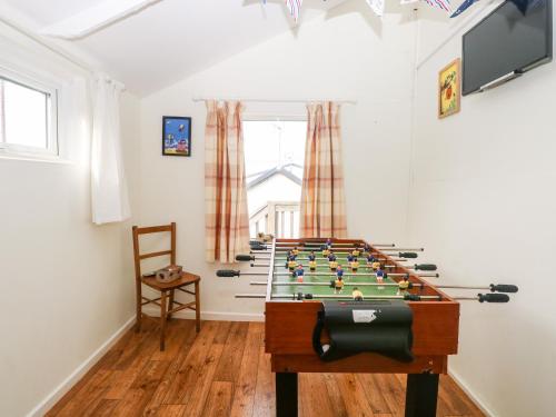 a room with a foosball table in the middle at Suzanne's Beach Hut in Norwich