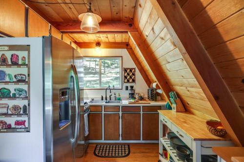 a kitchen with a refrigerator and a sink at Decks, Grills and Fire Pit Camp Connell Hideaway! in Camp Connell