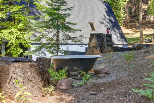 a bath tub sitting in front of a house at Decks, Grills and Fire Pit Camp Connell Hideaway! in Camp Connell