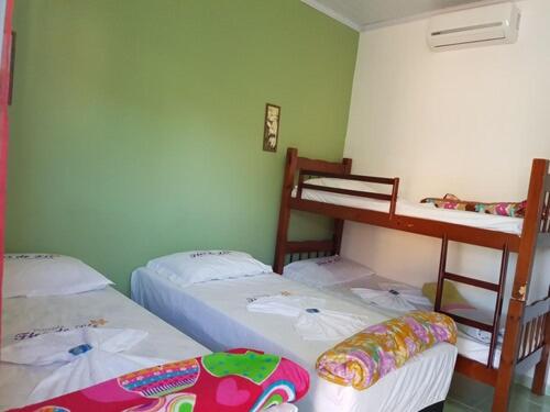 安格拉杜斯雷斯的住宿－Pousada Flor de Liz，客房设有两张床和一张双层床。