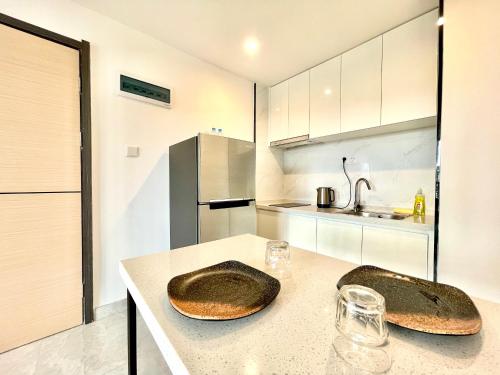 a kitchen with two bread bowls on a counter at Prince Mall Appartment - 400m to Sokha Beach in Sihanoukville