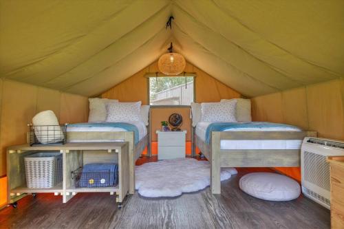 a bedroom with two beds in a tent at Hive Check - Safari Tent - BeeWeaver Honey Farm in Navasota
