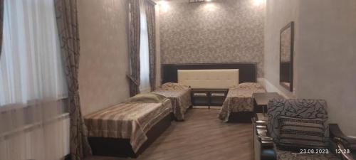 a room with two beds and a mirror at Chinar in Göyçay