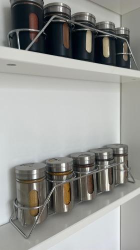 a shelf with many pots and pans on it at Heerlijk appartement Centrum Breda en restaurant! in Breda