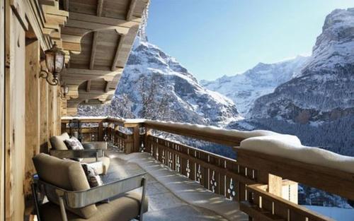 a balcony with chairs and a view of a mountain at Odalys Chalet Sporting Lodge in Plagne 1800