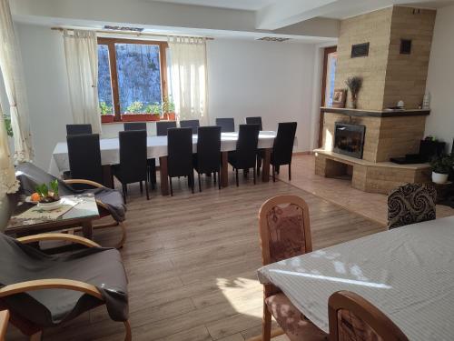 a dining room with a long table and chairs at Cabana AFTER HILL in Cluj-Napoca