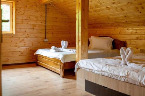 sypialnia z 2 łóżkami w drewnianym domku w obiekcie Cabana AFTER HILL w Klużu-Napoce