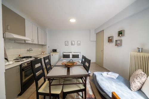 a kitchen and dining room with a table and chairs at The Florina Park House in Florina