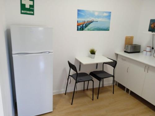 a kitchen with a small table and two chairs at Tropical Suite in Benalmádena