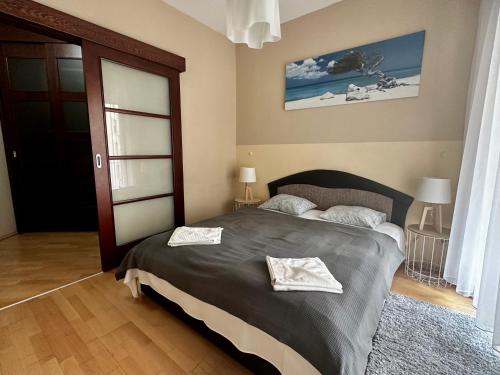 a bedroom with a bed with two towels on it at Leda Apartments in Budapest