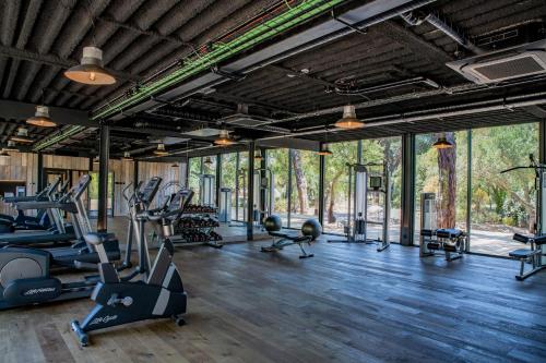 a gym with treadmills and elliptical machines at Sublime Comporta Country Retreat & SPA in Comporta