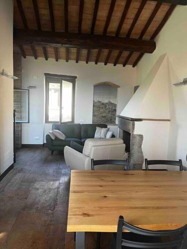 a living room with a couch and a table at Medieval Tower in Umbria with Swimming Pool in Monte lʼAgello