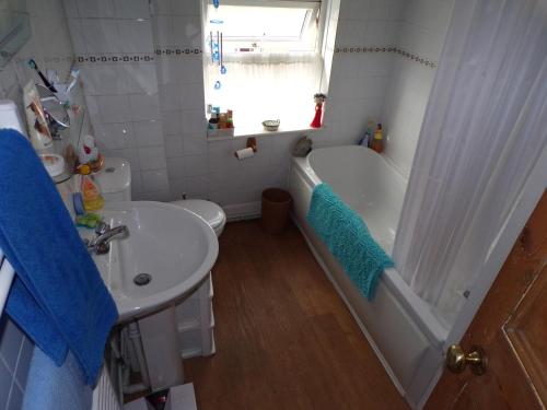 a bathroom with a tub and a sink and a toilet at enjoy your stay in Chester