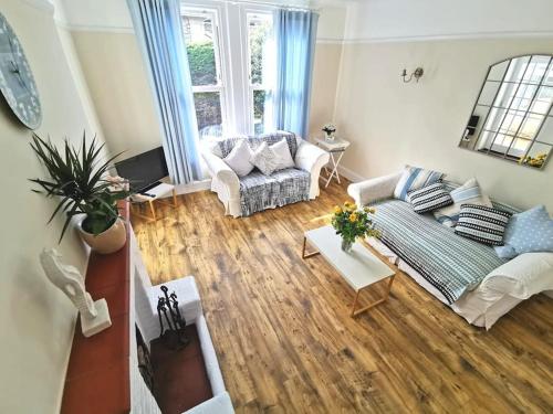 an aerial view of a living room with a couch at Beautiful gate house a 4 minute walk from beach in Bersted