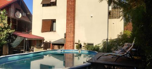 a swimming pool in front of a building at Hostel Golub in Zaječar