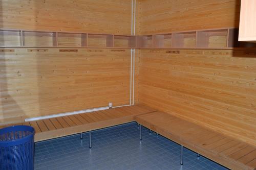 a sauna with wooden walls and benches in a room at Hotel Reima Country Center in Jämijärvi