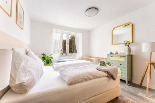 a bedroom with two beds and a mirror at Stay Awesome - Apartment Philosophenweg, Netflix and Disney in Kassel