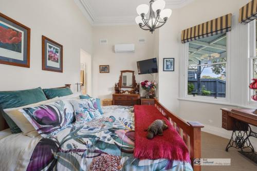 a bedroom with a bed with a teddy bear on it at Federation House on Genesta St Central Cowes in Cowes
