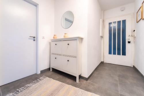 a room with a white cabinet and a door at Apartment Philosophenweg by stay awesome in Kassel