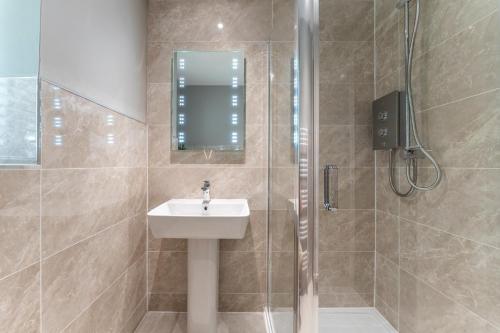 a bathroom with a sink and a shower at 33 Dunbar Court Gleneagles Village in Auchterarder