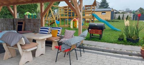 スバジェボにあるPokoje gościnne Jutrzenkaのパティオ(椅子、テーブル、プレイグラウンド付)