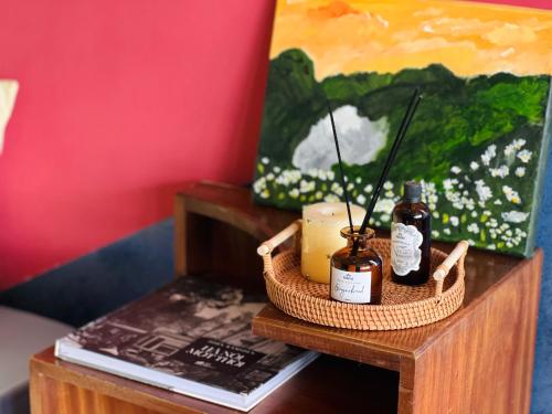 een tafel met twee flessen essentiële oliën en een schilderij bij 2BR/Rooftop/elevator/150m to Hoan Kiem Lake in Hanoi