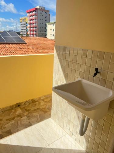 a sink in a bathroom with a view of a building at Residencial Negroni in Salinópolis