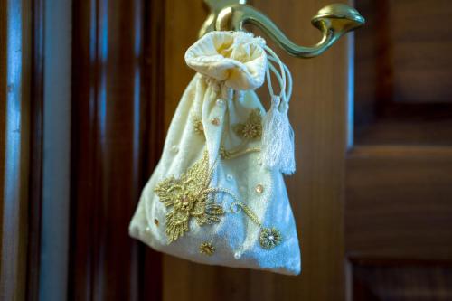 a towel hanging on a door handle at Archontiko Alexandros Luxury Suites in Kardiá