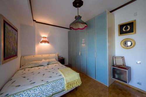 a bedroom with a bed and a blue cabinet at Archontiko Alexandros Luxury Suites in Kardiá