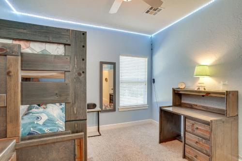 a bedroom with a wooden bunk bed and a desk at Quaint Noble Home 6 Mi to University of Oklahoma! in Norman