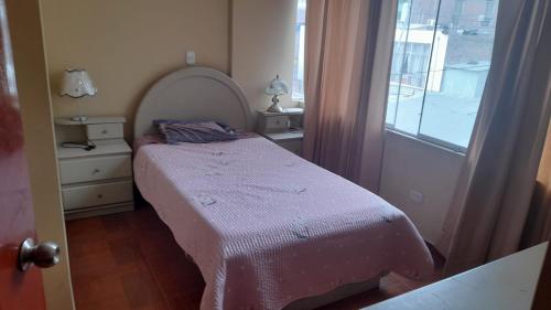 a small bedroom with a bed and a window at DEPARTAMENTOS AMOBLADOS EN JOSE LUIS BUSTAMANTE Y RIVERO AREQUIPA -PERU in Arequipa
