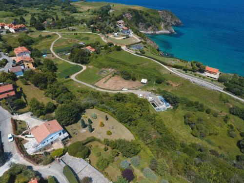 an aerial view of a house next to the ocean at Marina House in Pechón