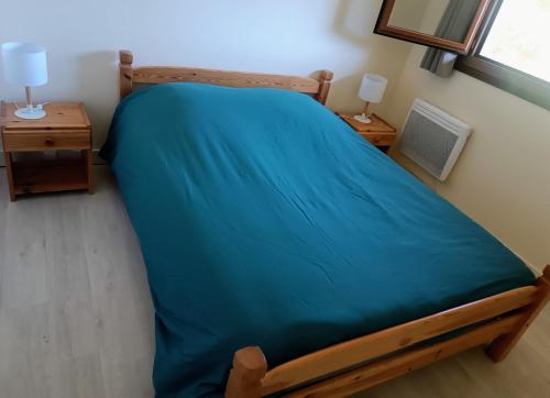 Tempat tidur dalam kamar di Les Ecureuils "Les Marmottes"