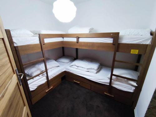 a group of bunk beds in a room at Superbe appartement à Isola 2000, 8 couchages, parking privé, à 5 min des pistes et commerces - FR-1-292-112 in Isola 2000