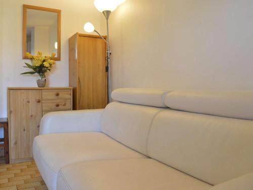 - un salon avec un canapé blanc et un miroir dans l'établissement Studio cosy à 1200m de la plage, à proximité commerces, port et golf, parking privé inclus - FR-1-249-13, au Cap d'Agde