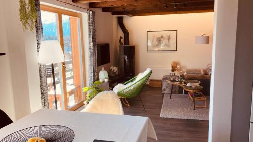 a living room with a couch and a table at Le Lézard et la Grenouille BnB in Ovronnaz